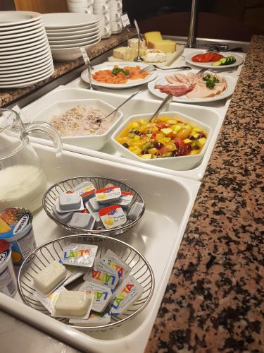a buffet line with many different types of food at Hotel Eremitage in Arlesheim