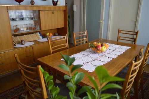 a dining room table with a bowl of fruit on it at Apartman Nikolic in Bor