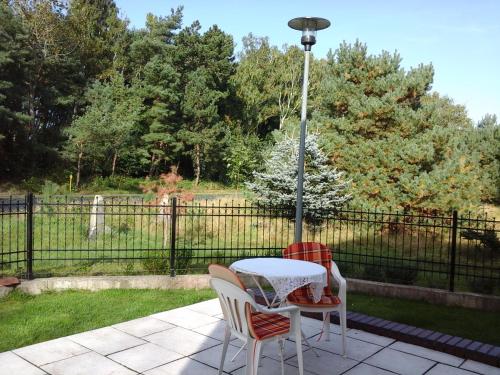 a table and chairs on a patio with a street light at Willa Olympia in Unieście