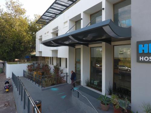 a person standing outside of a building at HI - Bnei Dan - Tel Aviv Hostel in Tel Aviv