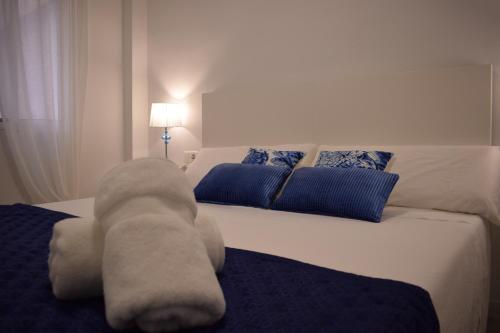 a bedroom with a bed with a stuffed animal on it at Apartamento Chapaprieta 1 in Torrevieja