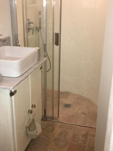a bathroom with a shower with a sink and a sink at Mamihouse in Gubbio