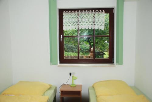 a bedroom with two beds and a window at Pension Tannenspitze in Lutherstadt Wittenberg