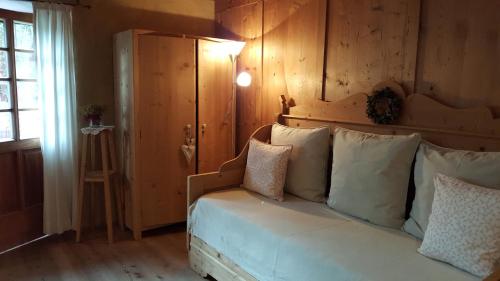 a bedroom with a bed with pillows on it at Landhaus Strickenmacher in Sillian