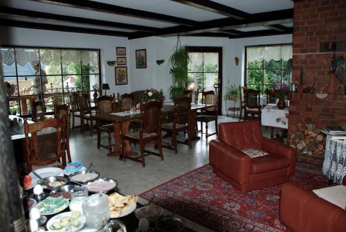 a living room with tables and chairs and a couch at Pension Tannenspitze in Lutherstadt Wittenberg