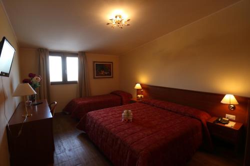 a hotel room with two beds and a window at Grand Hotel Stella Maris Italia in Palmi