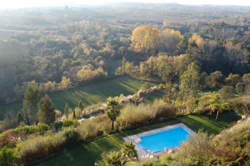 an aerial view of the estate with a swimming pool in a field at Quinta do Louredo Hotel in Espinhel