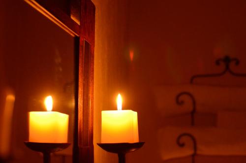 two candles sitting in front of a mirror at Hotel Boutique Tierra Magica in Tequila