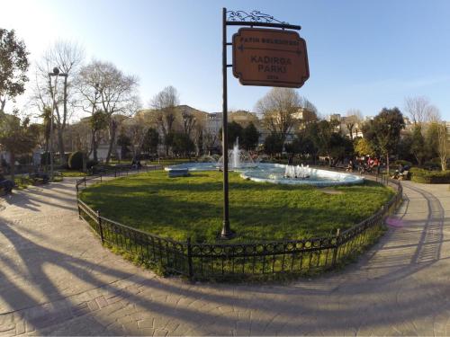 a sign in front of a fountain in a park at Blue Eye Suites in Istanbul