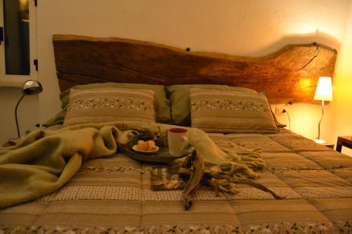 a bed with a blanket and a plate of food on it at Il Riuscello in Tuscania