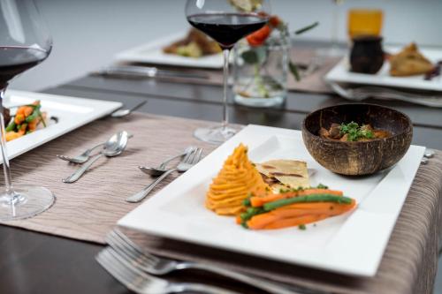 a table with plates of food and glasses of wine at Haus Mühlenbrock in Schermbeck