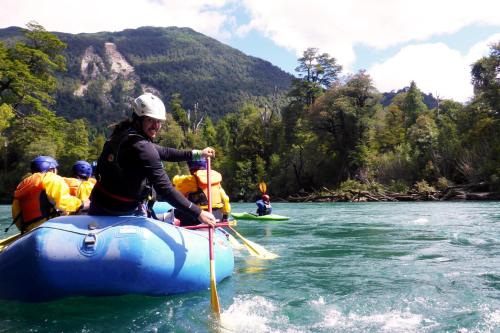 a group of people in a raft on a river at Apartamentos Yagan in La Junta