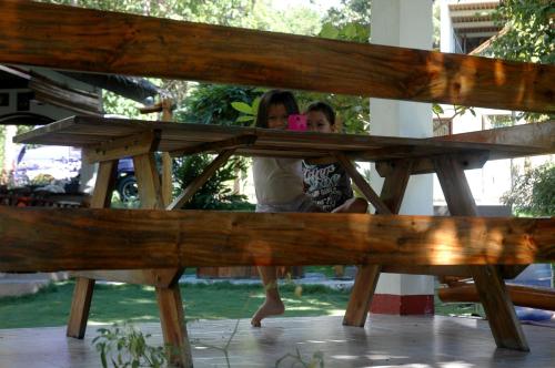 two girls are taking a picture in a picnic table at Neptune Diving Resort Santander in Santander