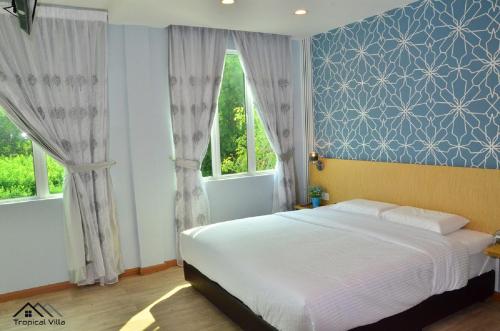 Krevet ili kreveti u jedinici u okviru objekta Tropical Villa Kuantan