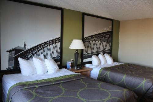 a hotel room with two beds and a bridge at Super 8 by Wyndham Kearney in Kearney