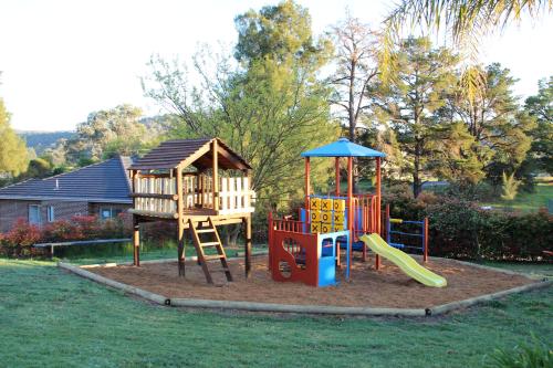 a playground with a slide and a play structure at Hume Country Motor Inn in Albury