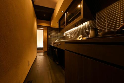 a kitchen with a sink and a counter top at Kuraya Kamigojocho in Kyoto
