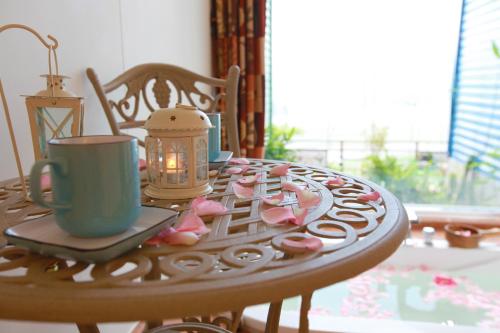 a table with a candle and a cup and cookies on it at Hao Wang Jiao House in Datong
