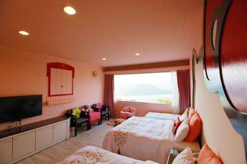 a hotel room with two beds and a large window at Hao Wang Jiao House in Datong