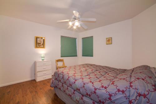 a bedroom with a bed and a ceiling fan at Red Rock Vacation Villa in Las Vegas