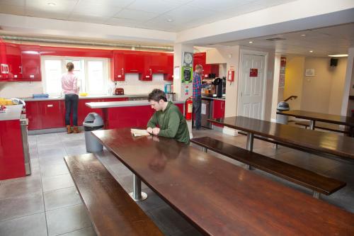 
a woman standing in a kitchen next to a counter at Sleepzone Hostel Galway City in Galway
