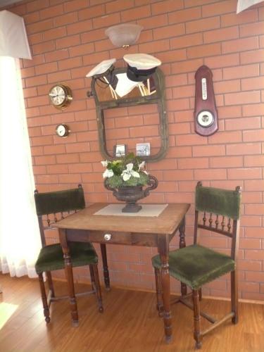 a table with two chairs and a mirror on a wall at Grong Grong Motor Inn in Grong Grong