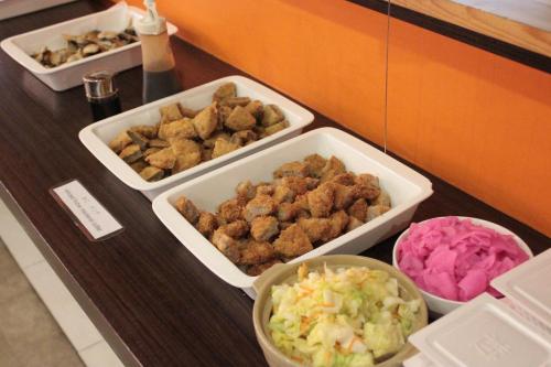 a buffet with three trays of food on a counter at CVS Bay Hotel in Urayasu