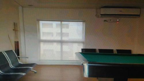 a room with a pool table and a window at 2 BR Sorrento Oasis in Manila