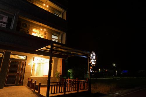a building with a porch at night with a sign at Miyama Bed and Breakfasts in Chishang