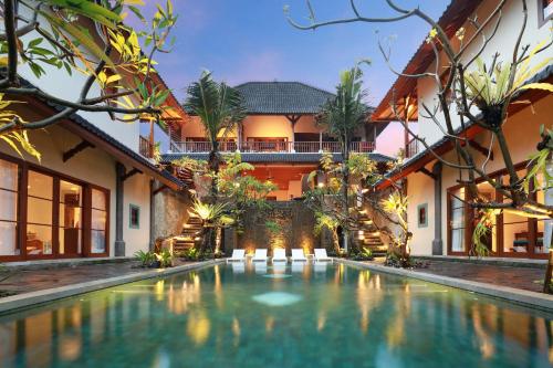 a house with a swimming pool in front of a house at Korurua Dijiwa Ubud in Ubud