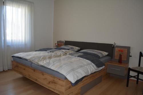 una camera con letto in legno e cuscini sopra di Ferienwohnung Sonnenkamp a Schmallenberg