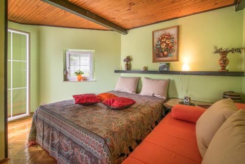 a bedroom with a bed with red pillows on it at Lucy in Krk
