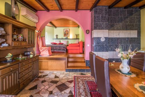 a living room with a table and a pink room at Lucy in Krk