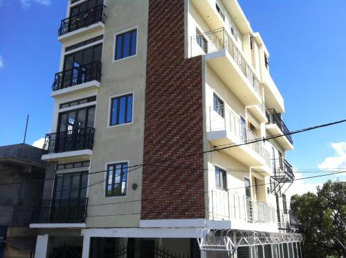 a tall white building with black windows and balconies at MountView studio in city in Port Louis