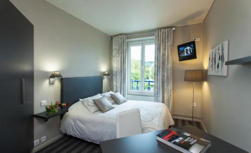 Postel nebo postele na pokoji v ubytování Hotel Restaurant Les Capucins