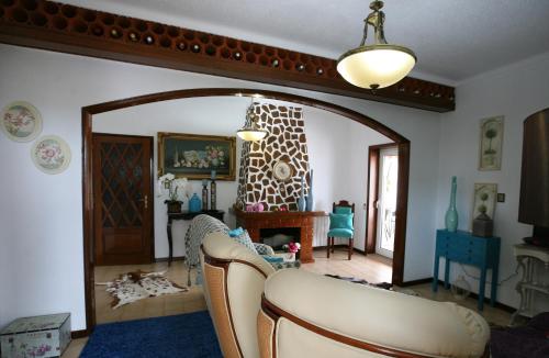a living room with a couch and a mirror at Casa Flor do Campo in Celorico de Basto