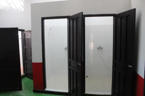 a bathroom with two mirrors in a room at Y Not Laos Hostel in Luang Prabang