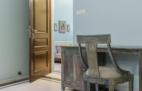 a wooden chair sitting next to a counter in a room at The Almond Tree in Jodhpur