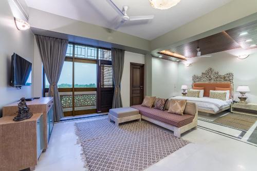 a living room with a bed and a couch at The Almond Tree in Jodhpur