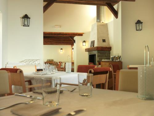 a dining room with tables and chairs and a fireplace at Hotel Continental Balneario de Panticosa in Panticosa