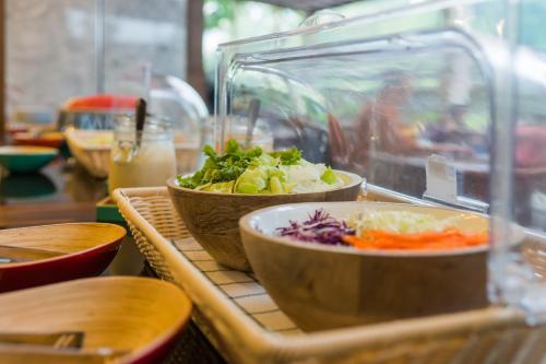 a table with two bowls of food on a table at Olive Tree Hotel Pattaya in Na Jomtien