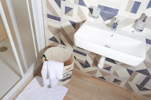 a bathroom with a sink and a trash can at APARTMÁNY RYBNÍČEK in Staré Město