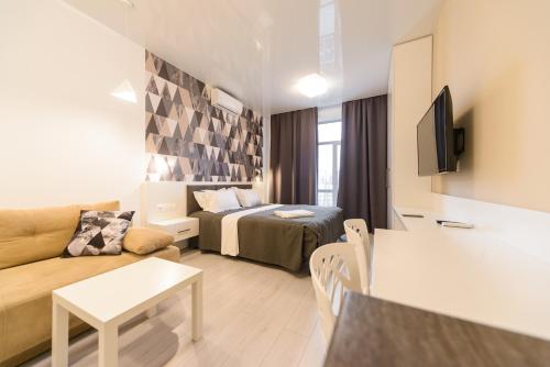 a small living room with a bed and a couch at Partner Guest House Baseina in Kyiv