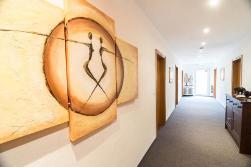 a hallway with a large painting on the wall at Haus Mühlenbrock in Schermbeck