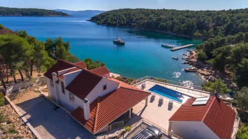 an aerial view of a house and a lake at Luxury Villa Kate - in Lucice Bay with turquoise sea, Amazing Seaviews, and Heated Pool in Milna