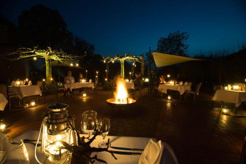a patio with tables and lights at night at Haus Mühlenbrock in Schermbeck