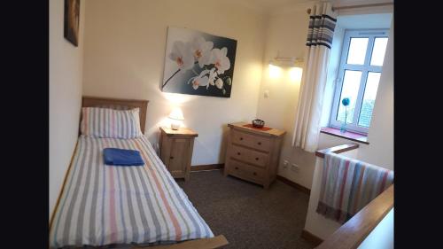 Ένα ή περισσότερα κρεβάτια σε δωμάτιο στο Elgin Self Catering Holiday Cottage