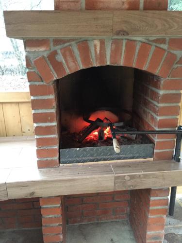 a brick oven with a fire in it at Chata Nezábudka in Oščadnica