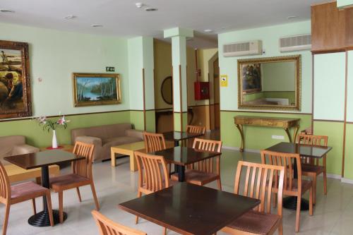 a restaurant with tables and chairs in a room at Hotel Mirador Puerta del Sol in Madrid