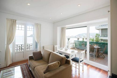a living room with a couch and a table at BREATHTAKING TERRACE VIEWS in luxury apartment - by www,SanSebastianApartments,es in San Sebastián